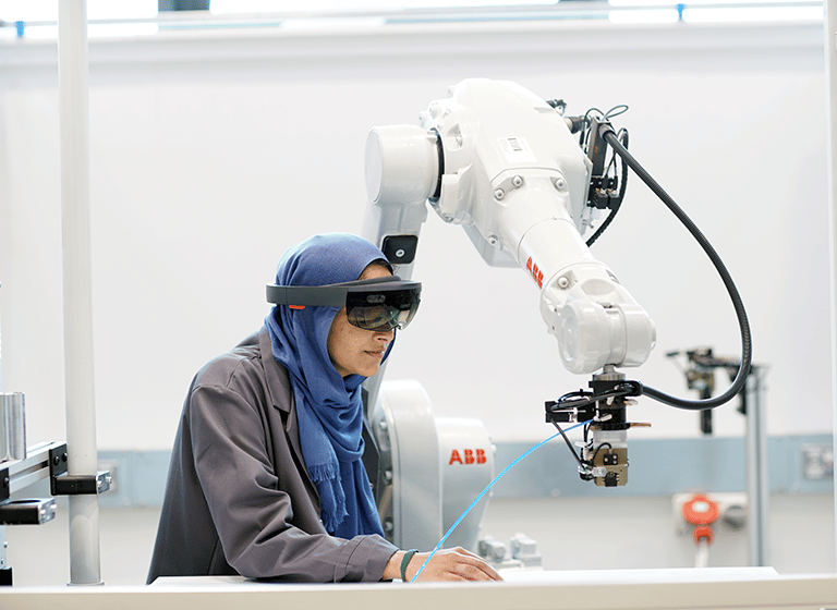 Manufacturing researcher using equipment