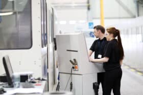 Apprentices use manufacturing equipment