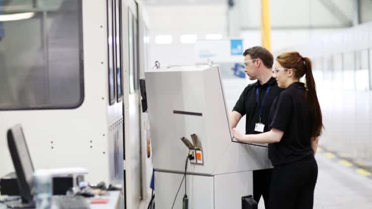Apprentices use manufacturing equipment