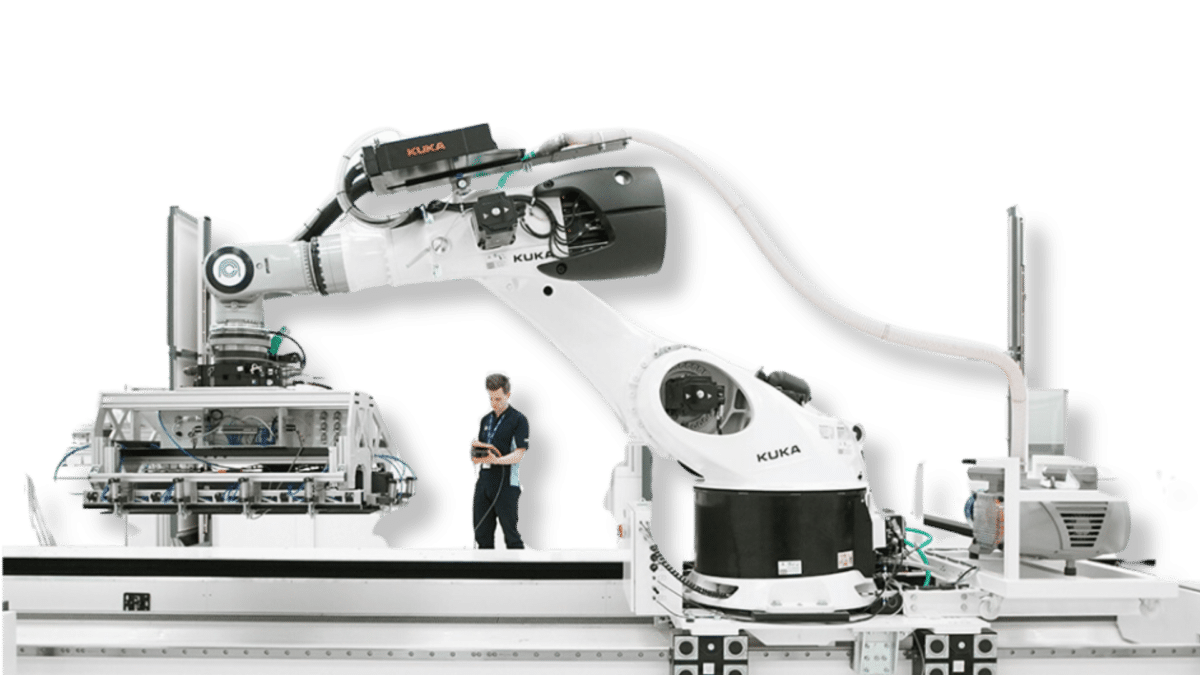 Engineer working with large white robot arm