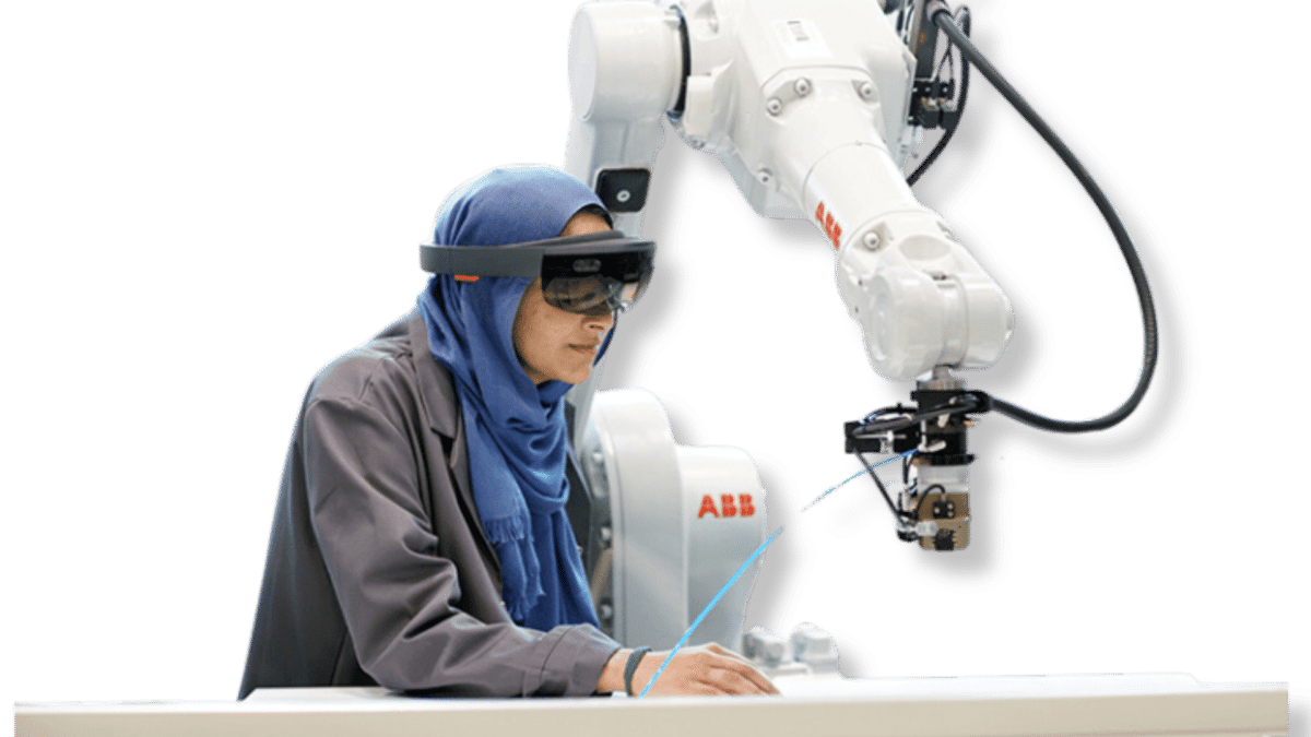 female engineer working with VR glasses and robotic arm.